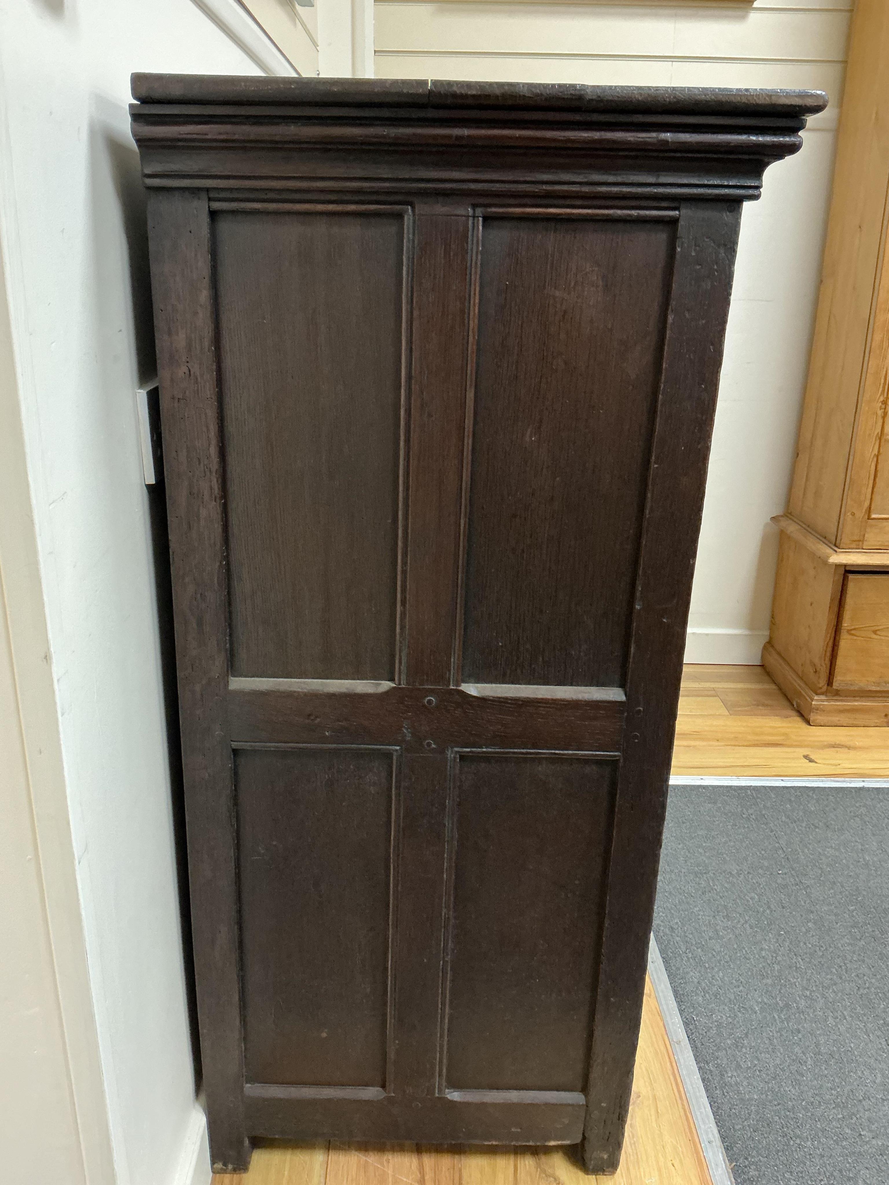 An 18th century and later French carved oak two door cabinet, width 115cm, depth 53cm, height 115cm